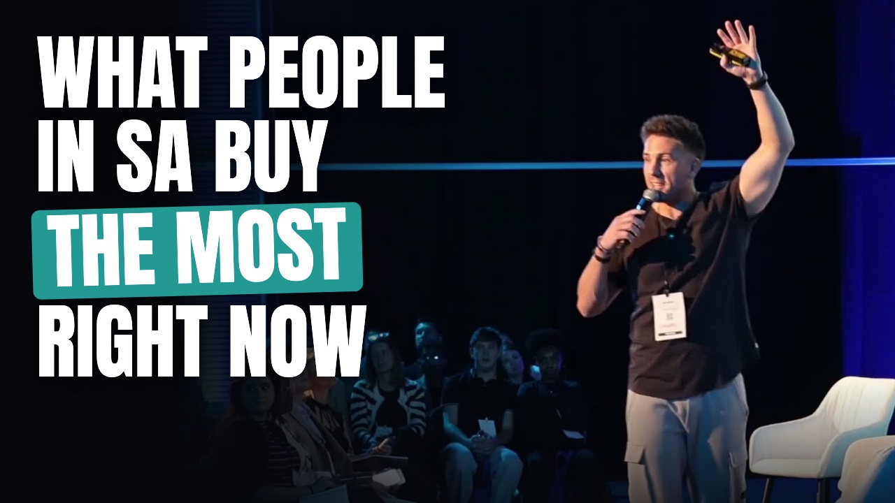 Jandre de Beer on stage at an ecommerce event, talking about what people in South Africa buy the most right now